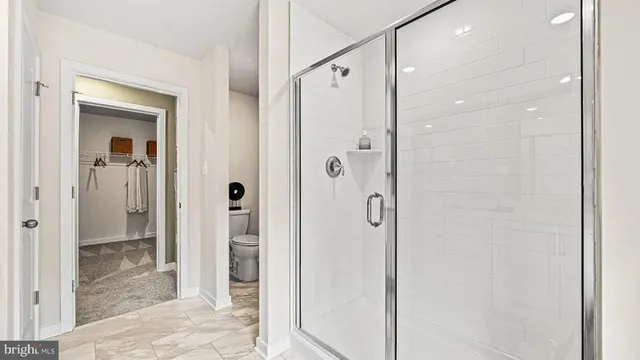 a bathroom with a glass shower door