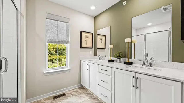 a bathroom with 2 sink and a mirror