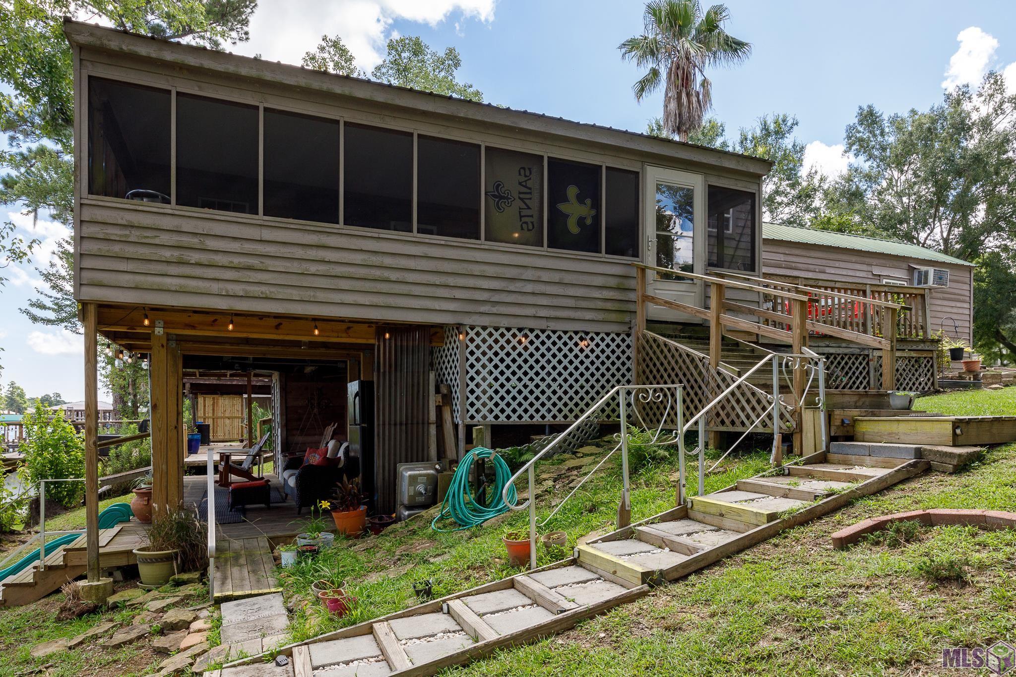 21054 Diversion Canal Road St. Amant, LA 70774 - Photo 6 of 48 Enclosed Patio & Lower Covered Deck
