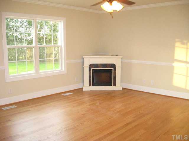 5596 Brogden Road Smithfield, NC 27577 - Photo 4 of 12 Great living room with ceiling fan, hardwoods, & electric fireplace