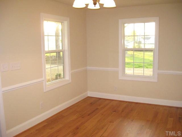 5596 Brogden Road Smithfield, NC 27577 - Photo 5 of 12 Lovely dining area with chair rail, tall windows, & hardwoods