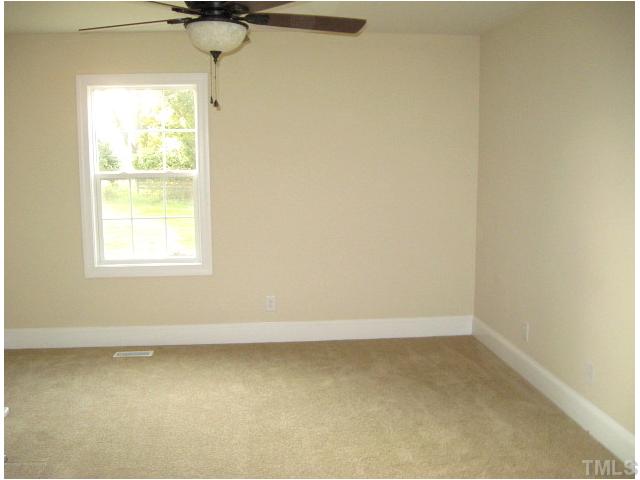 5596 Brogden Road Smithfield, NC 27577 - Photo 6 of 12 First floor master suite with ceiling fan & his/hers closets