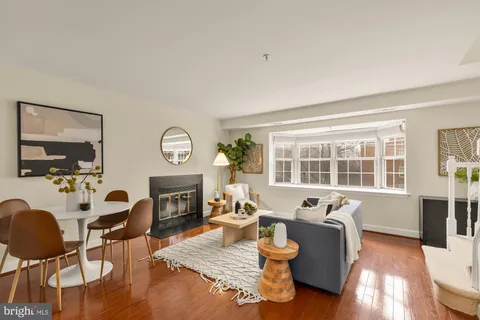 a living room with fireplace furniture and a large window