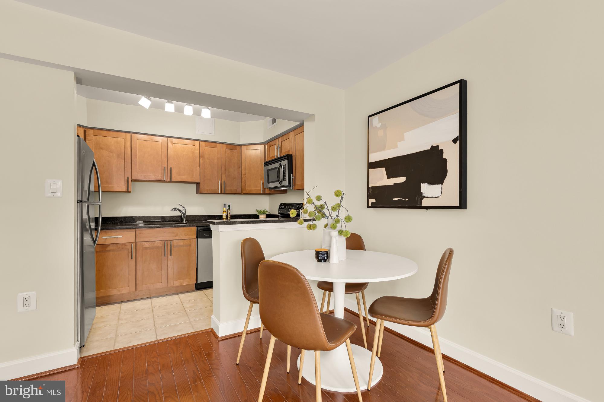 3804 Rodman Street Northwest, Unit 303 Washington, DC 20016 - Photo 13 of 32 a view of kitchen with cabinets and wooden floor