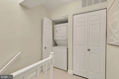 a bathroom with a granite countertop sink a toilet a mirror and shower