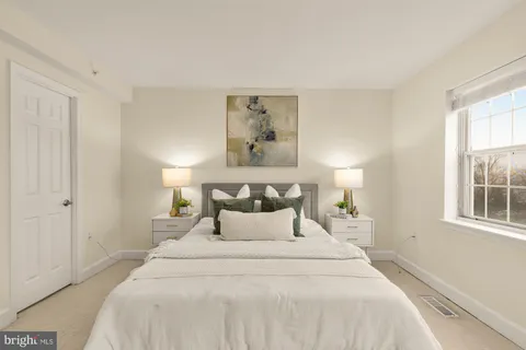 a bedroom with a bed and cabinets