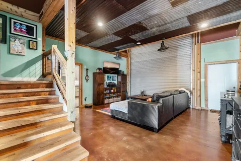 a living room with furniture and stairs