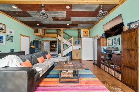 a living room with furniture a rug and a chandelier