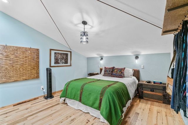 a bedroom with double bed and a window