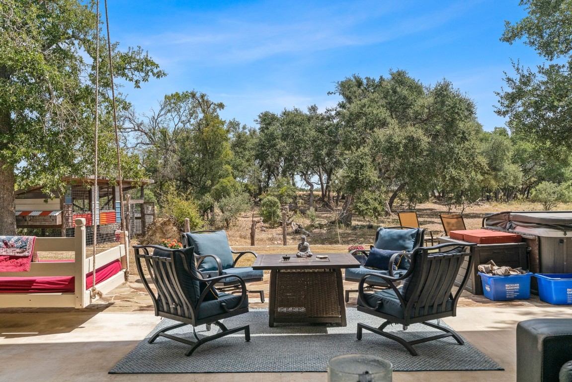 7394 Creek Road Dripping Springs, TX 78620 - Photo 23 of 39 a view of backyard with seating space and trees in the background