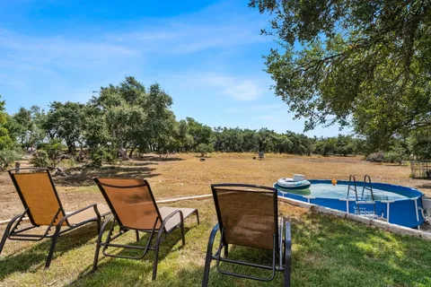 a view of a lake with table and chairs