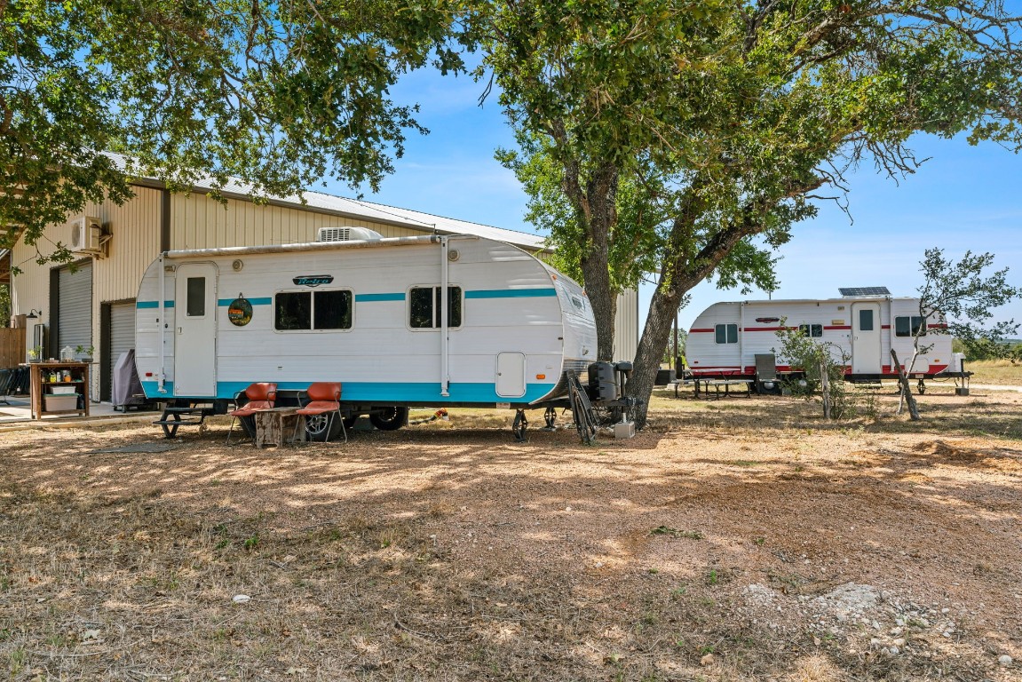 7394 Creek Road Dripping Springs, TX 78620 - Photo 33 of 39 a view of a house with backyard and a tree