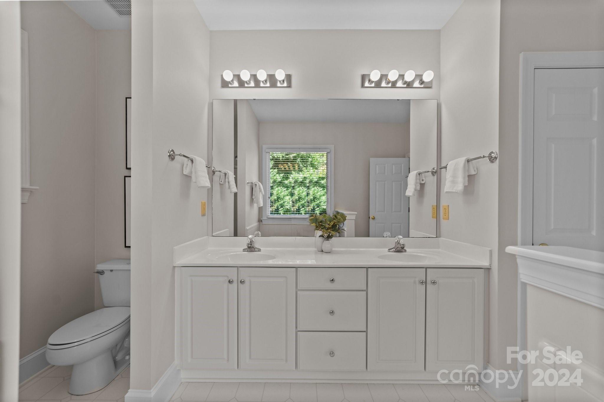 101 North Kimberly Road Davidson, NC 28036 - Photo 23 of 38 a bathroom with a toilet a sink and mirror