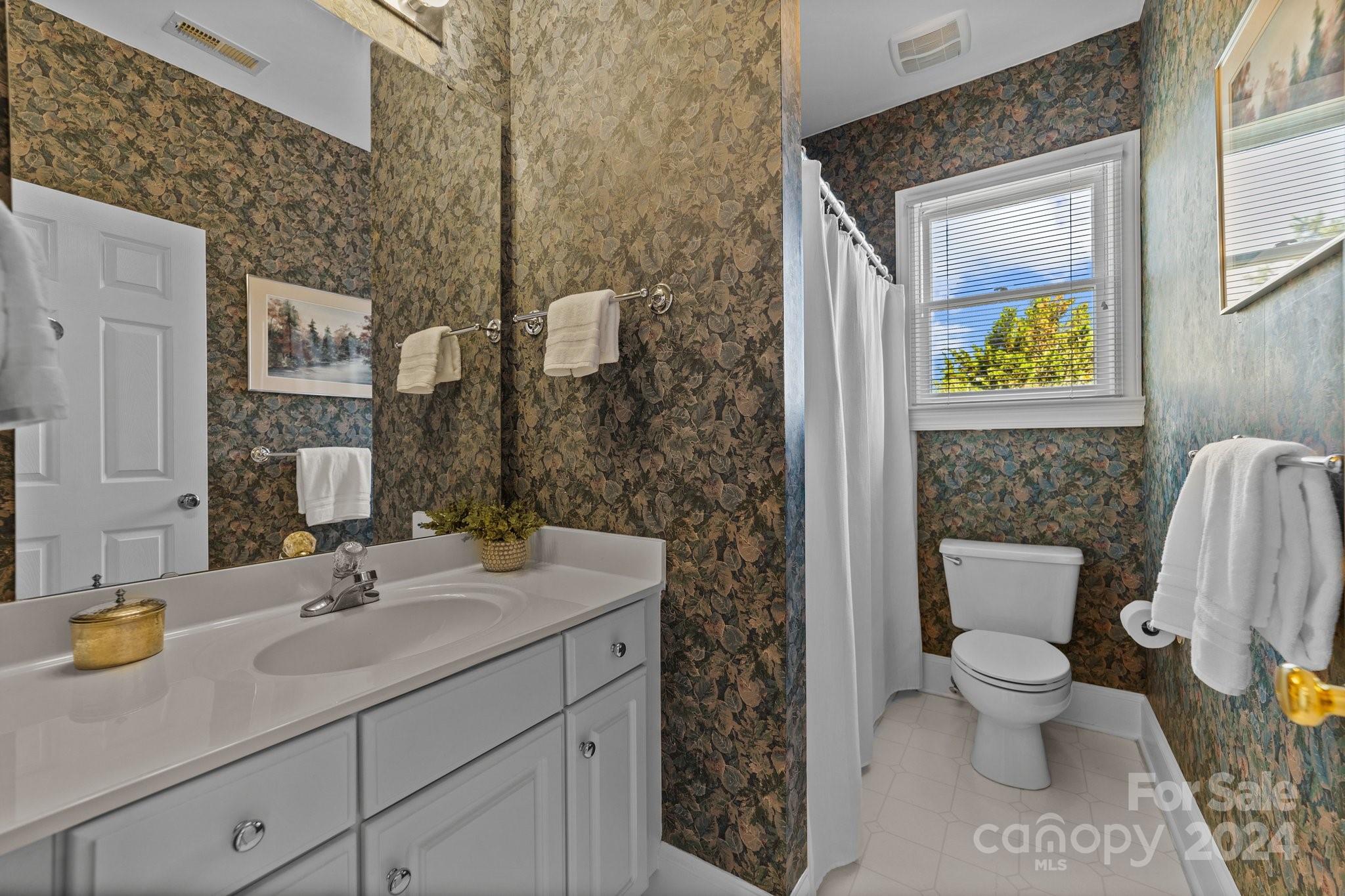 101 North Kimberly Road Davidson, NC 28036 - Photo 25 of 38 a bathroom with a granite countertop sink a toilet and a mirror