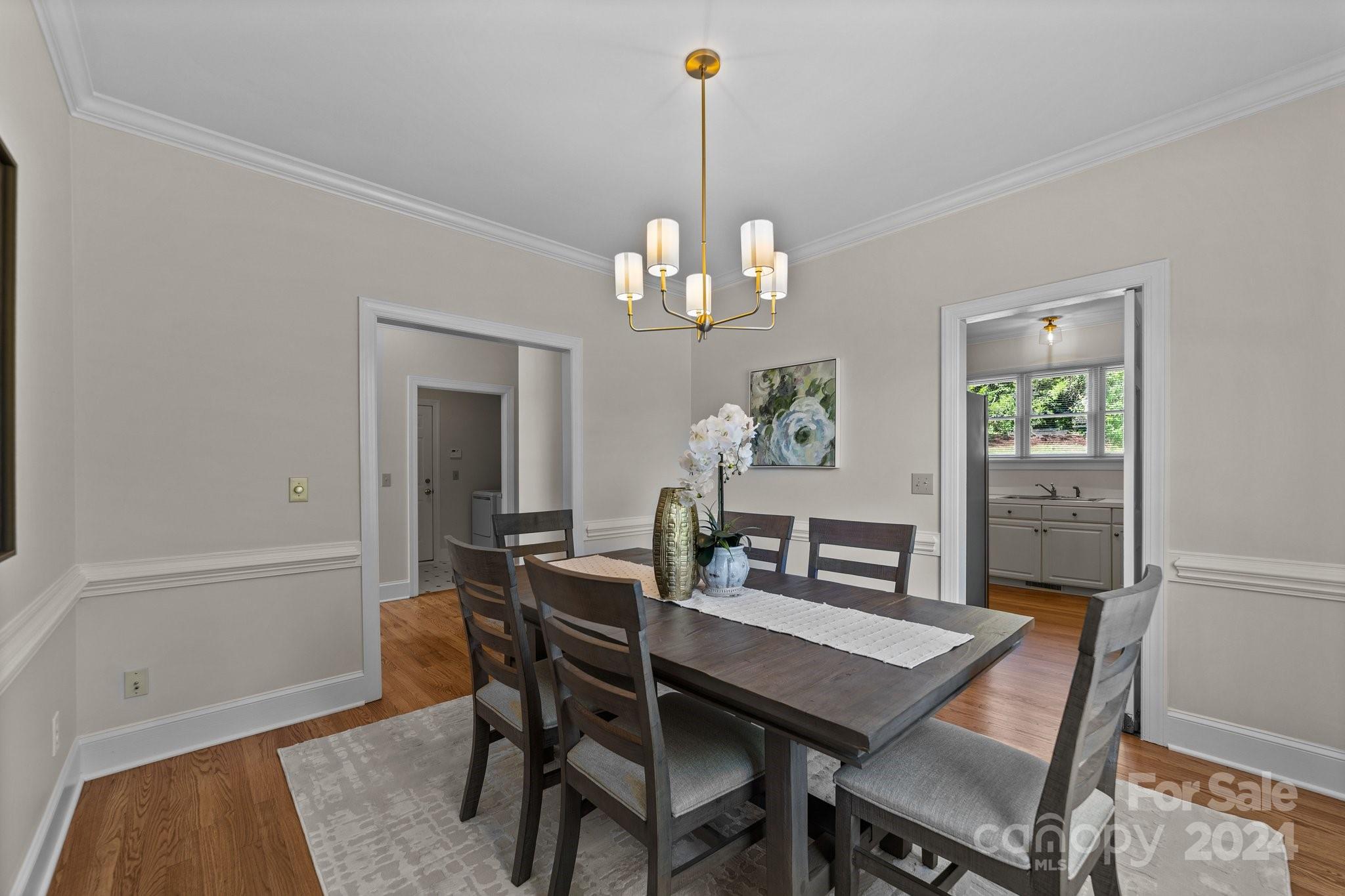 101 North Kimberly Road Davidson, NC 28036 - Photo 9 of 38 a dining room with wooden floor a chandelier a wooden table and chairs