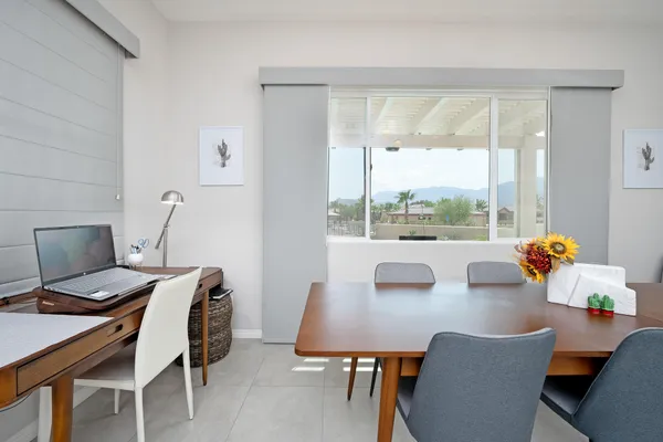 a view of a dining room with a table and chairs