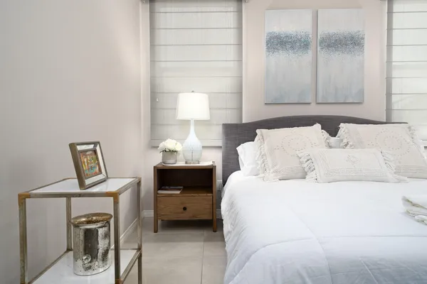 a bedroom with a bed a couch and dresser