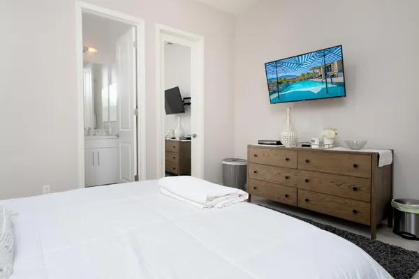 a bedroom with a bed and a cabinet