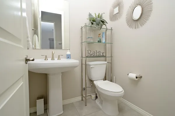 a bathroom with a sink a toilet and mirror