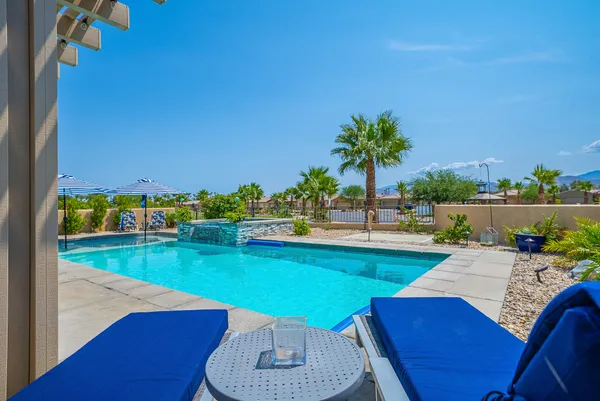 a view of a swimming pool with an outdoor seating