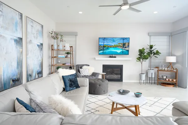 a living room with furniture a fireplace and a flat screen tv