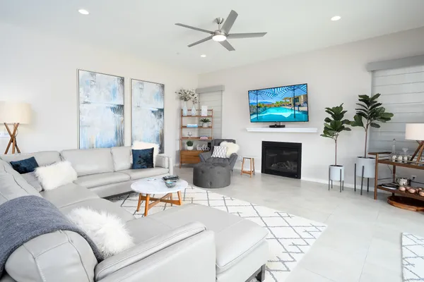 a living room with furniture a fireplace and a flat screen tv