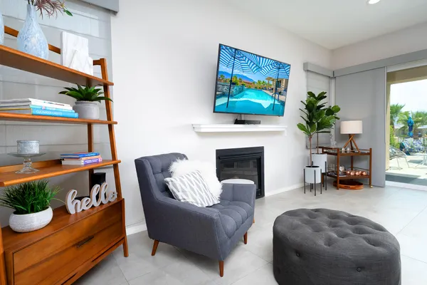 a living room with furniture a fireplace and a window