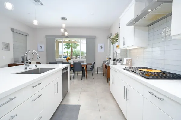 a kitchen with sink stove and cabinets