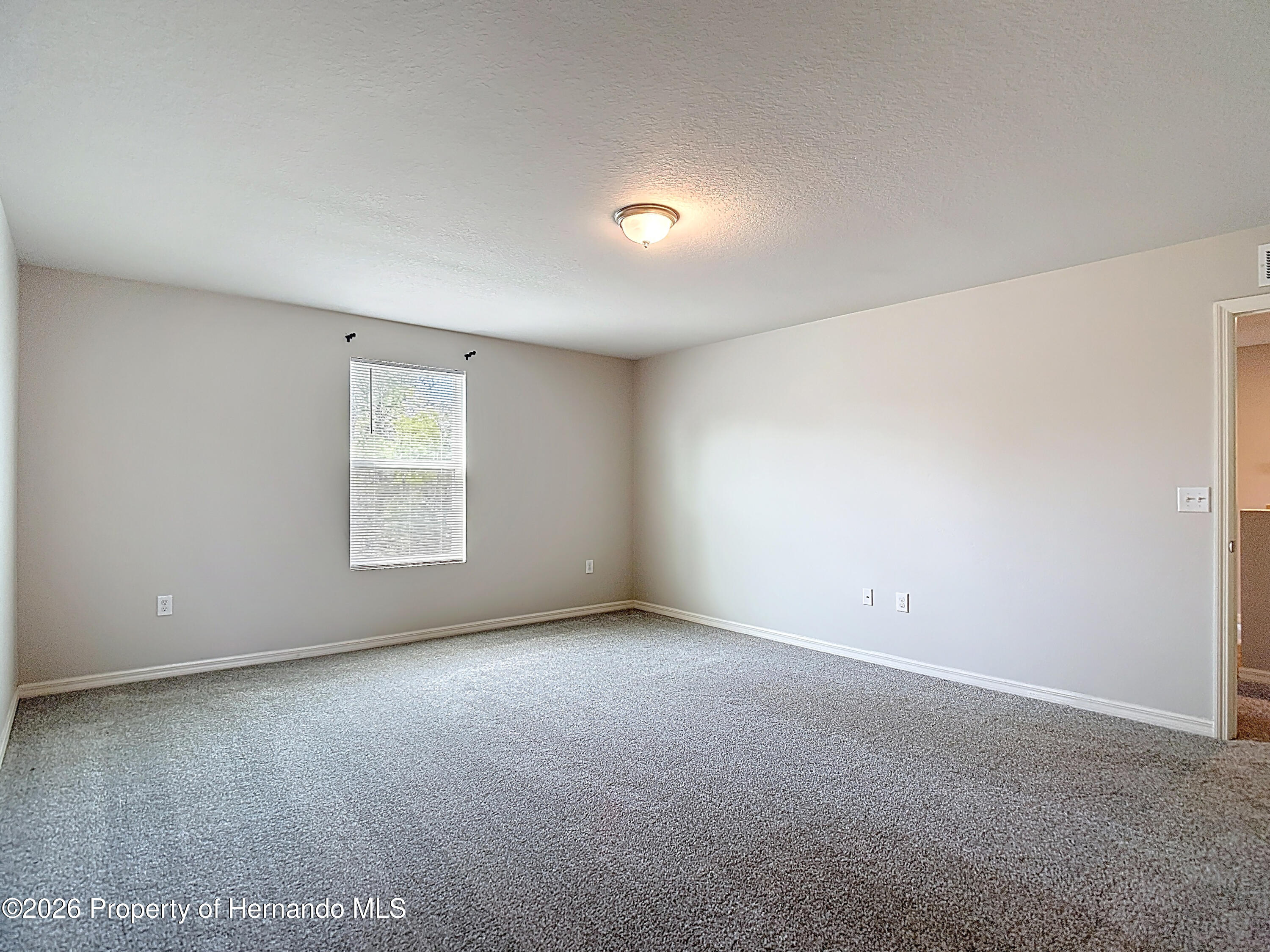 11374 Marcella Avenue Weeki Wachee, FL 34614 - Photo 40 of 70 an empty room with windows