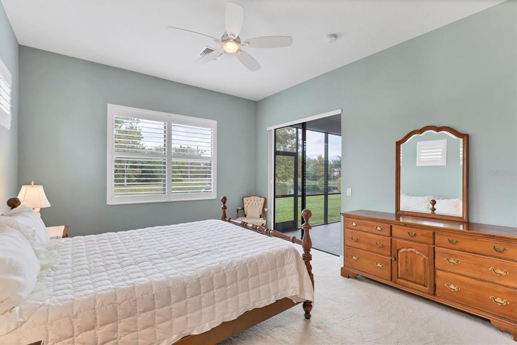 7909 Rio Bella Place Bradenton, FL 34201 - Photo 12 of 38 a spacious bedroom with a bed and a dresser