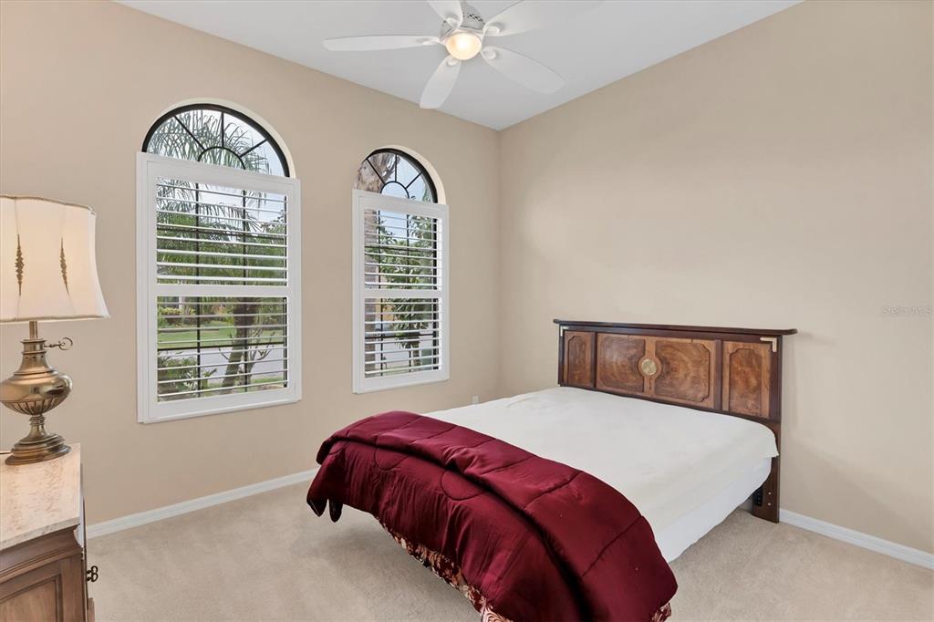 7909 Rio Bella Place Bradenton, FL 34201 - Photo 15 of 34 a bedroom with a bed and a large window