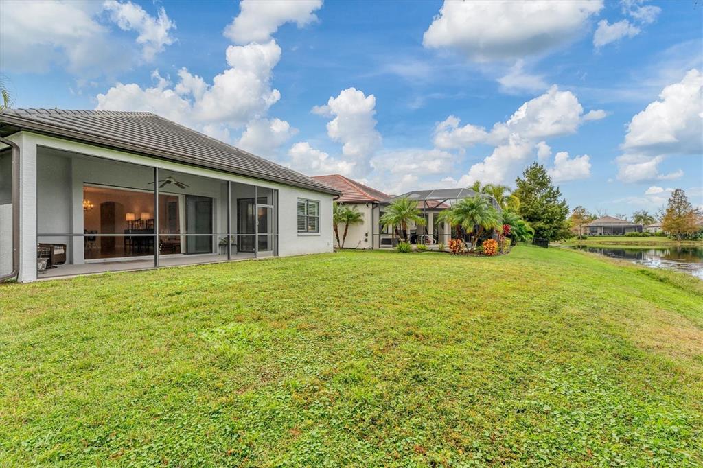 7909 Rio Bella Place Bradenton, FL 34201 - Photo 24 of 38 a view of a house with yard and sitting area