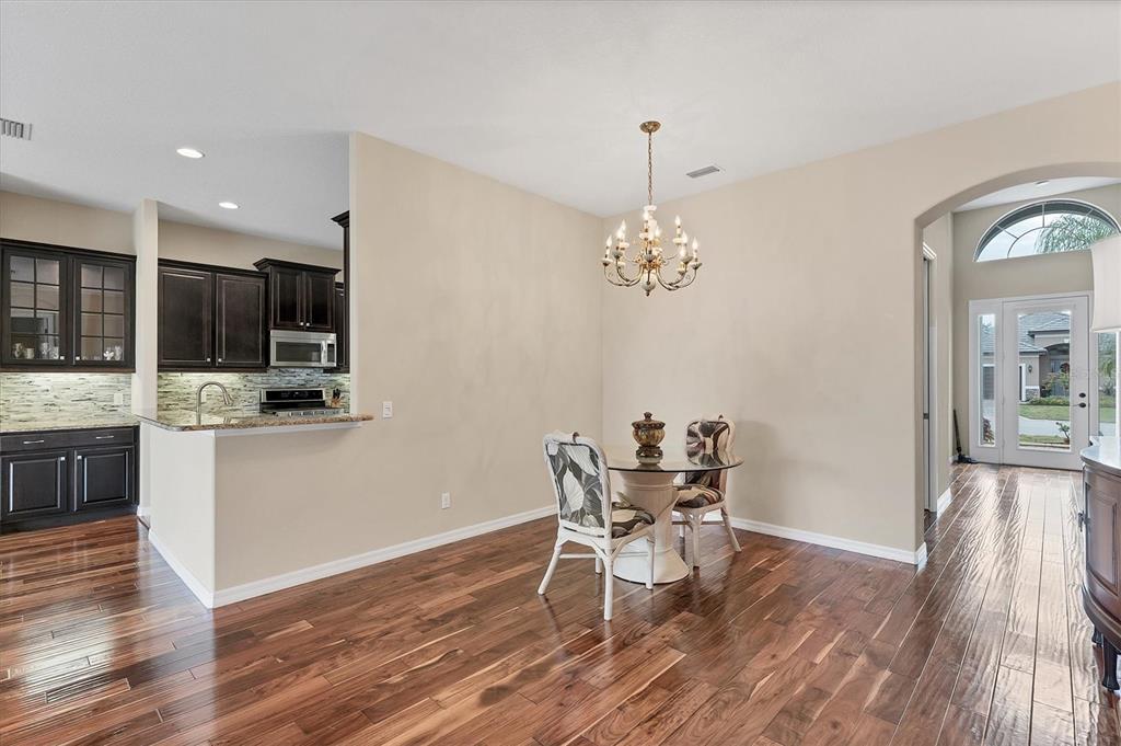 7909 Rio Bella Place Bradenton, FL 34201 - Photo 7 of 38 a view of a dining room with furniture window and wooden floor