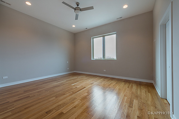 2835 West Division Street, Unit 4E Chicago, IL 60622 - Photo 10 of 25 wooden floor in an empty room with a window
