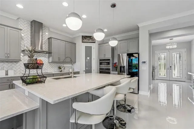a kitchen with a sink a counter top space and stainless steel appliances