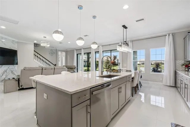 a large kitchen with a table and chairs