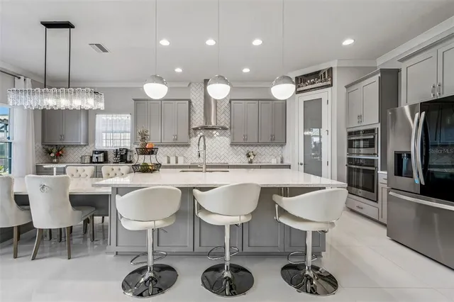 a large kitchen with a table and chairs