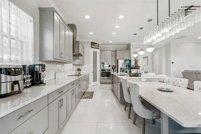 a large kitchen with stainless steel appliances kitchen island granite countertop a sink and cabinets