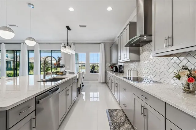 a kitchen with stainless steel appliances kitchen island granite countertop a sink and cabinets