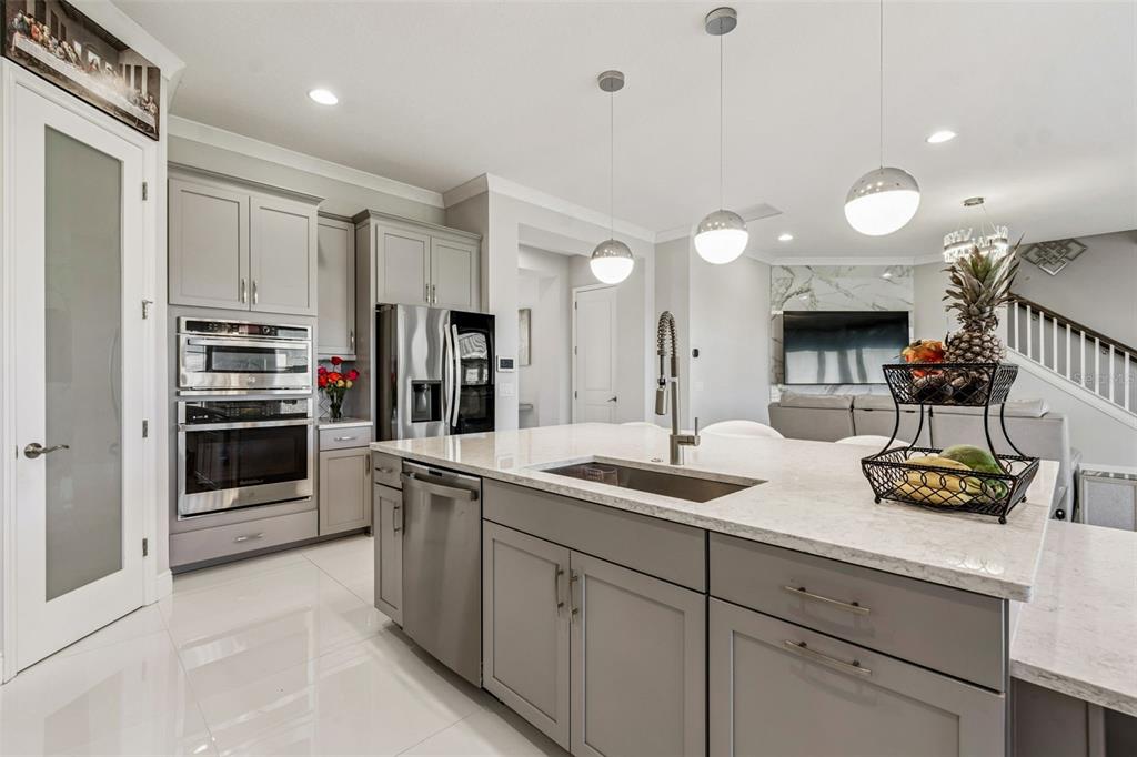 10863 Rustic Timber Loop San Antonio, FL 33576 - Photo 18 of 56 a kitchen with stainless steel appliances kitchen island granite countertop a sink and cabinets