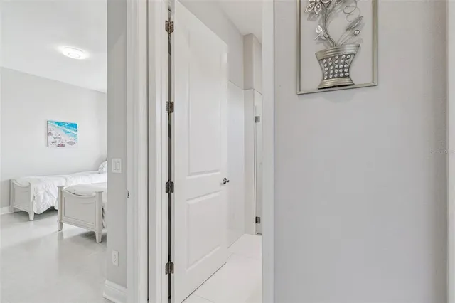 a bedroom with two beds and a lamp on the dresser