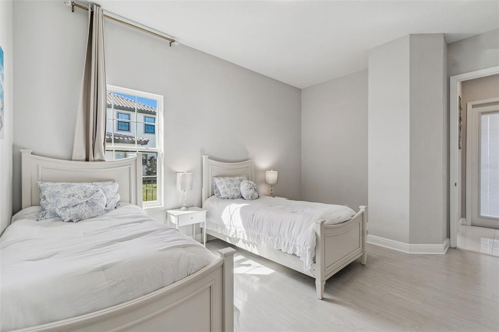 10863 Rustic Timber Loop San Antonio, FL 33576 - Photo 21 of 56 a bedroom with a bed lamp and a large window