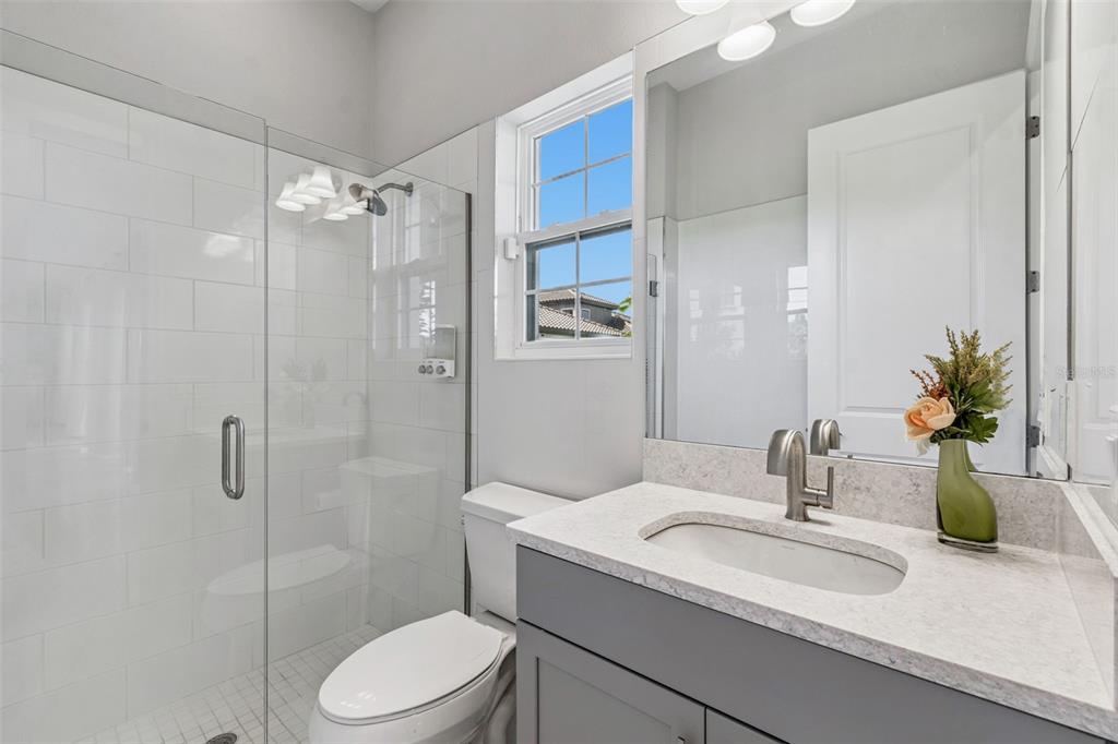 10863 Rustic Timber Loop San Antonio, FL 33576 - Photo 22 of 56 a bathroom with a sink toilet and shower