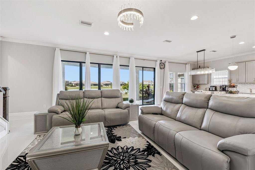 10863 Rustic Timber Loop San Antonio, FL 33576 - Photo 24 of 56 a living room with furniture kitchen view and a large window