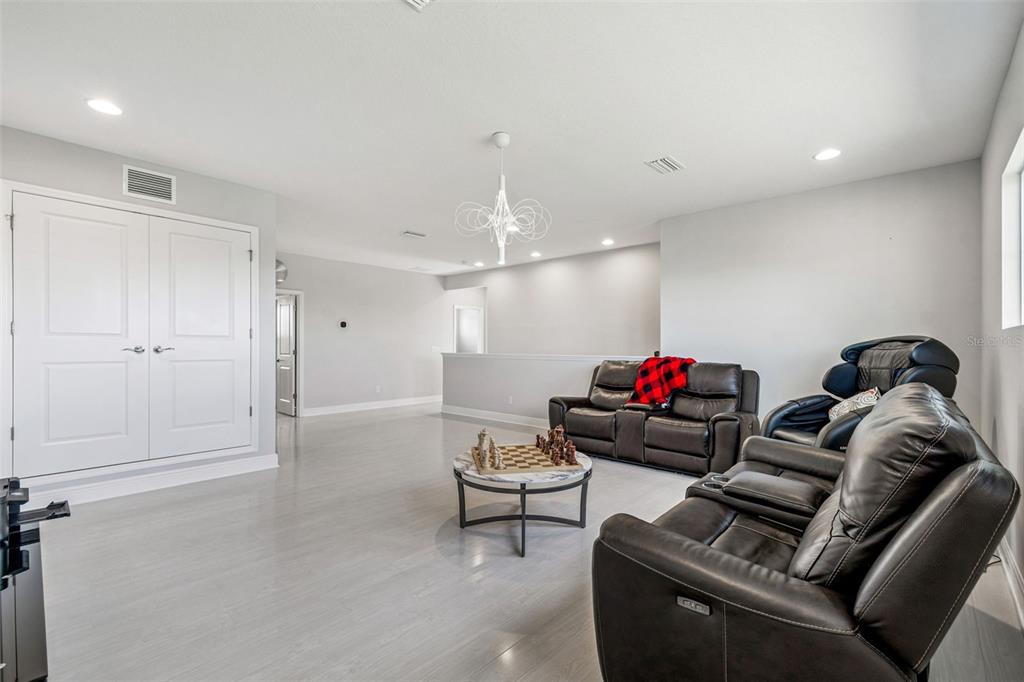 10863 Rustic Timber Loop San Antonio, FL 33576 - Photo 26 of 56 a living room with furniture and a chandelier