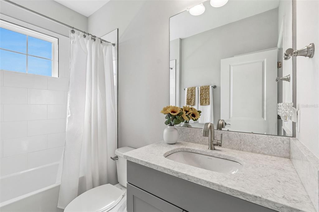 10863 Rustic Timber Loop San Antonio, FL 33576 - Photo 29 of 56 a bathroom with a granite countertop sink toilet and shower
