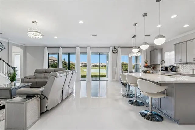 a living room with lots of furniture and white cabinets