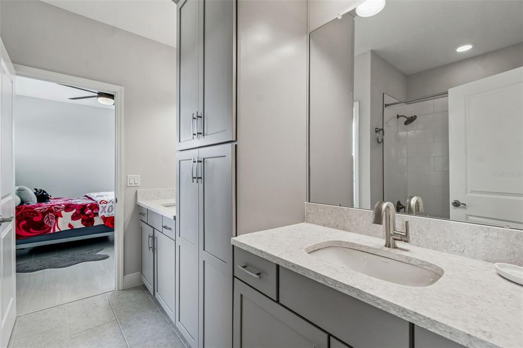 10863 Rustic Timber Loop San Antonio, FL 33576 - Photo 32 of 56 a bathroom with a sink and a mirror