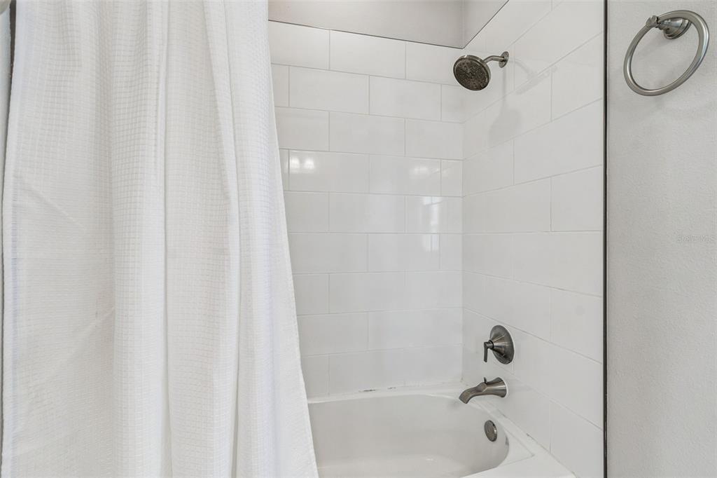 10863 Rustic Timber Loop San Antonio, FL 33576 - Photo 33 of 56 a bathroom with a shower and a bathtub