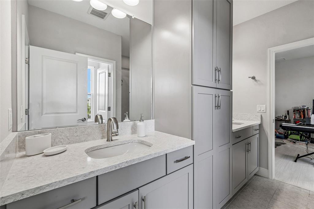 10863 Rustic Timber Loop San Antonio, FL 33576 - Photo 35 of 56 a bathroom with a sink and a mirror